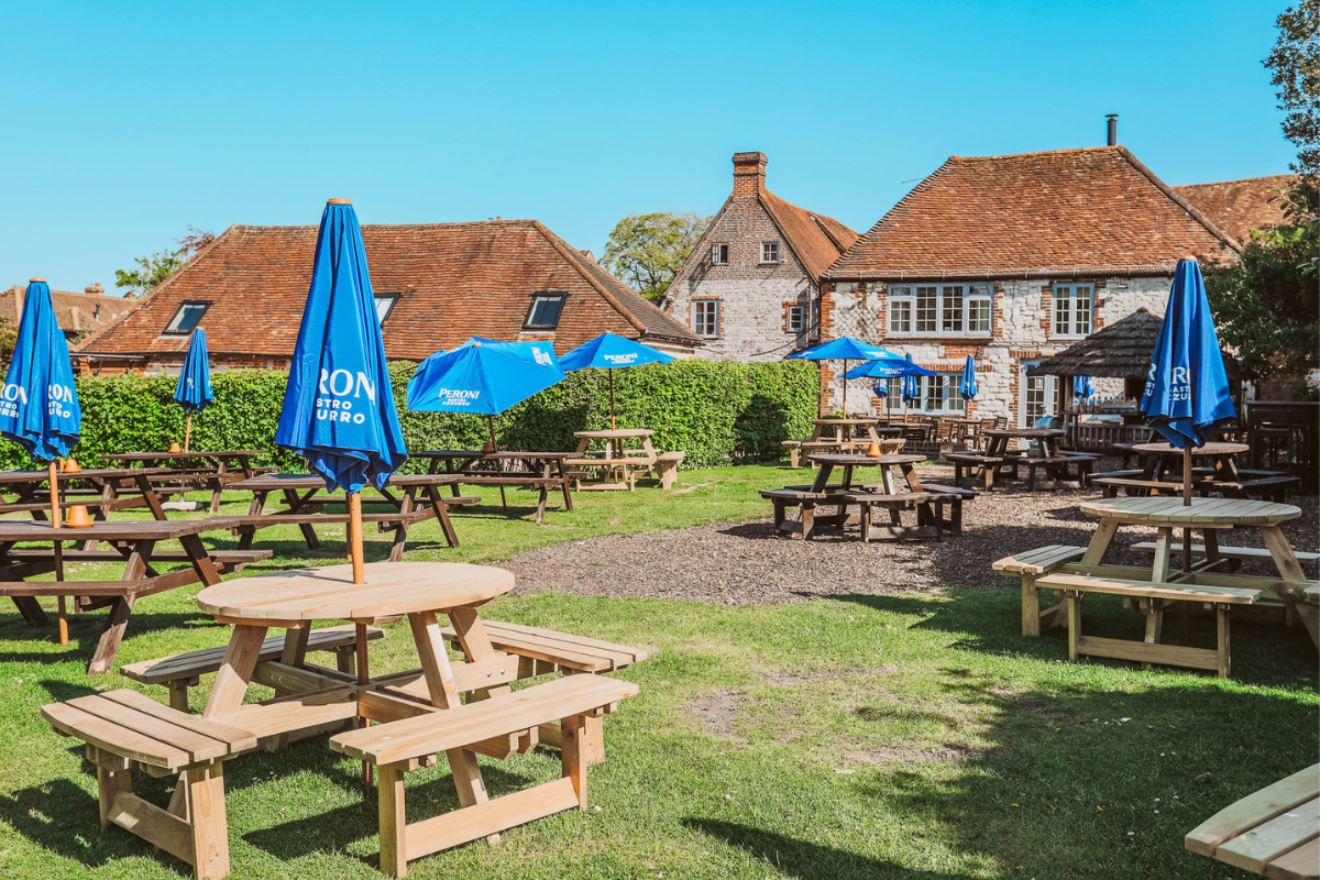 Outside dining in the garden at the White Hart pub with rooms in South Harting near the South Downs